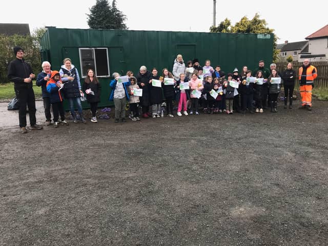 Danderhall Guerrilla Gardeners' young volunteers received certificates after giving up their holiday time to help turn a derelict site into community woodlands.