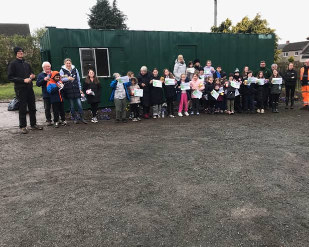 Danderhall Guerrilla Gardeners' young volunteers received certificates after giving up their holiday time to help turn a derelict site into community woodlands.