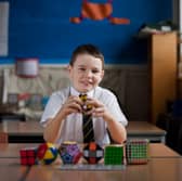 Nine-year-old Darrin Mcdonald sits for a portrait with his Rubik's cubes after setting a new record at his school, Balgreen Primary, in February 2012.