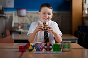 Nine-year-old Darrin Mcdonald sits for a portrait with his Rubik's cubes after setting a new record at his school, Balgreen Primary, in February 2012.