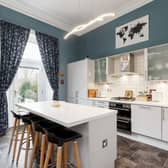 At the back of the property, there is a modern fitted kitchen with integrated appliances and breakfast bar as well as access to the private terrace through a recently replaced patio door. 