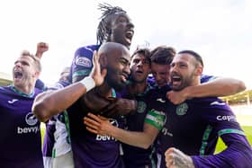 Who’s calling? Maolida is mobbed by his Hibs team-mates after scoring. Again. 