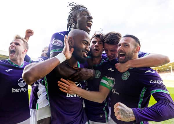 Who’s calling? Maolida is mobbed by his Hibs team-mates after scoring. Again. 