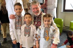 Dnipro Kids chairman Steven Carr with some of the kids in traditional Vyshyvanka shirts.