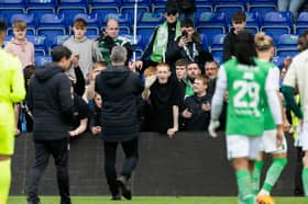 Hibs staff and players engage with travelling fans after the weekend collapse in Dingwall.