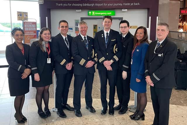 Joe Fox stands with his United Airlines crew at Edinburgh Airport