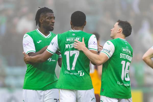 Nah, we aren't letting you go ... Myziane Maolida is embraced by Rocky Bushiri and Lewis Stevenson after scoring one of his 11 goals for Hibs.