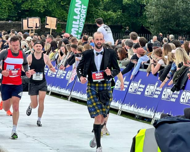 Stephen Molloy crossing the finish line at the Edinburgh Marathon 2024