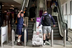 Scotland fans head to the departure lounge at Glasgow airport.