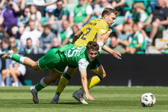 Staying grounded: Rudi Molotnikov tangles with Celtic's Alistair Johnston in Sunday's 2-0 home loss to the champions.