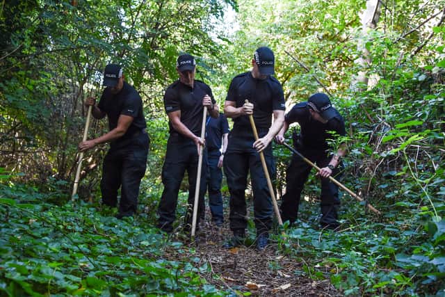 Police officers out searching woods near Khasha’s home on Wednesday, September 4.