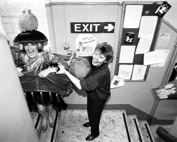Una McLean finds the corridor too narrow for her elaborate costume during rehearsals for the pantomime Aladdin at the King's theatre Edinburgh, December 1991.