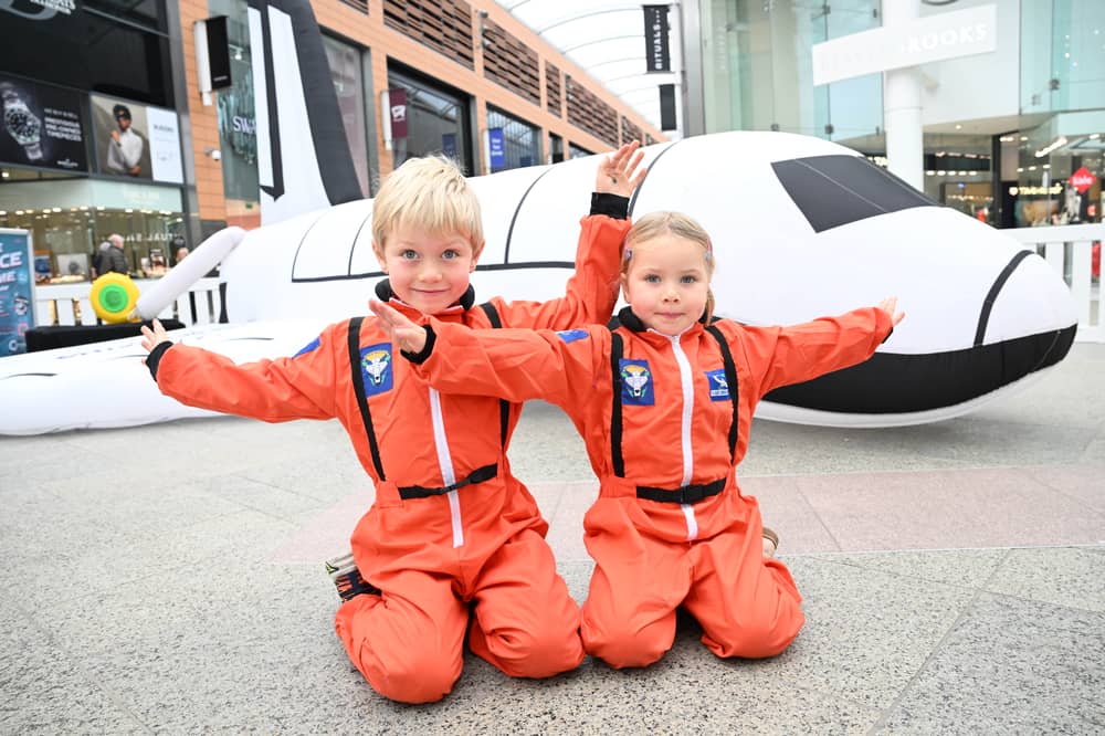 Cameron, 6, and Ailsa, 4, in front of a space shuttle at the Space Dome event at the Centre, Livingston.