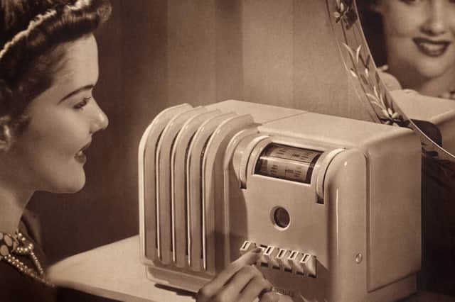 A woman listens to a Bakelite radio in the 1940s