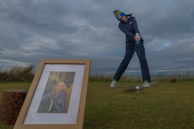 Tara Carrick, an ambassador for My Name'5 Doddie Foundation, tees off at Renaissance Club, East Lothian, with an image of her mum Claire, who lost her life to MND last year.