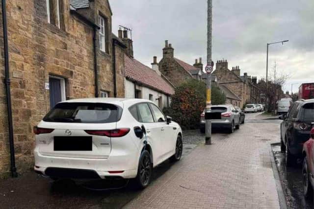 The home owner argues that the area outside his Pathhead home is used for parking and should have an EV charge.