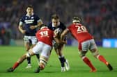 Stafford McDowall of Scotland is tackled by Teddy Williams and Aaron Wainwright of Wales during the Guinness Six Nations 2025 match between Scotland and Wales at Scottish Gas Murrayfield (Pic: SNS)