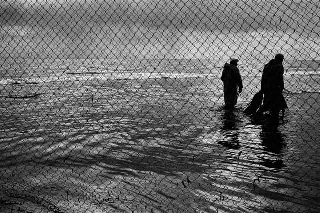 Two salmon net fishermen making their way home across the beach after fishing jumpernets at Kinnaber, Angus in 2000. PIC: Colin McPherson