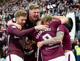 Hearts' Frankie Kent (R) celebrates scoring to make it 1-0 with teammates.