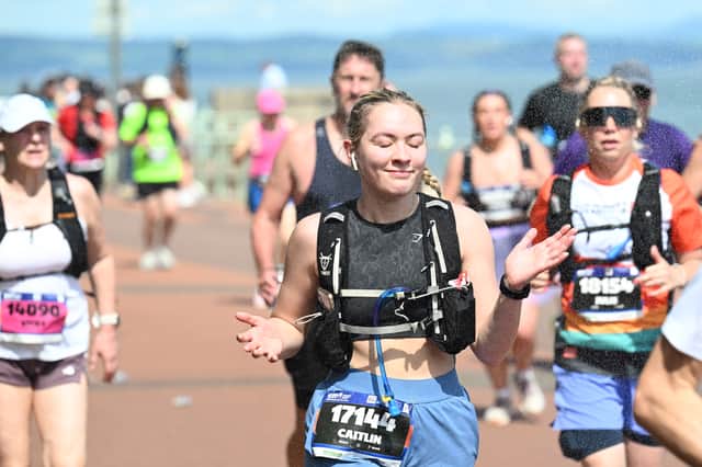 Some spectators provided runners with some relief from the heat by spraying water over them as they passed