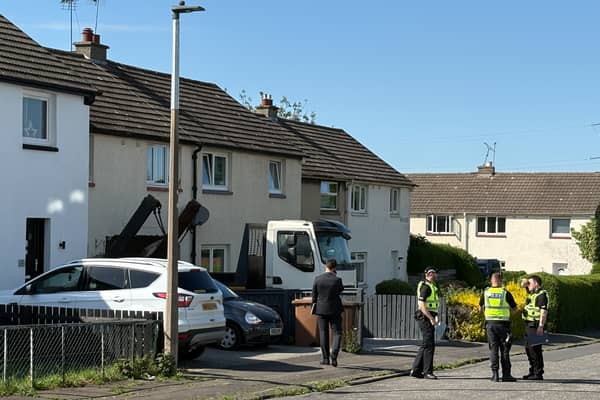 Police officers at the scene where a lorry has crashed into a house on Brand Drive, Edinburgh. 