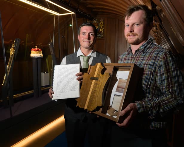 Oli Beatson, Lead Craftperson, and Andrew Carlberg-Husband, Joiner, with the time capsule in the Crown Room at Edinburgh Castle