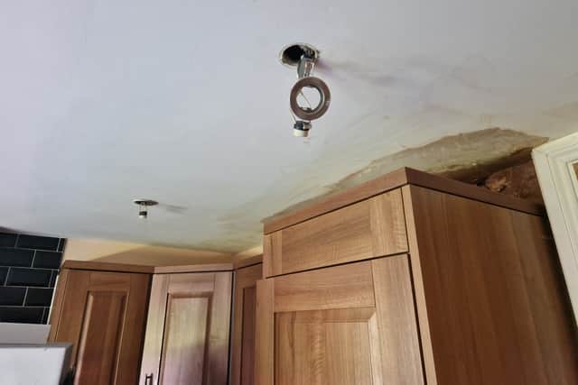 Spotlights damaged during the leak, hang from the ceiling