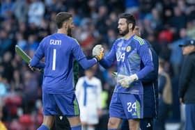 Scotland's Angus Gunn (left) shakes hands with Craig Gordon during an friendly match  against Finland at Hampden on June 07, 2024.