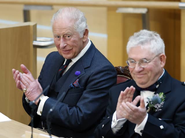 King Charles III applauds with Presiding Officer Kenneth Gibson MSP in the Debating Chamber during the opening of the seventh session of the Scottish Parliament in Edinburgh
