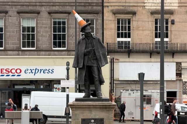 A traffic cone erected on the statue of Sherlock Homes
