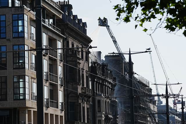View of firefighters on a high platform tackling a building fire