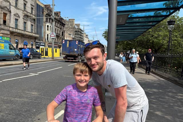 Denny Lawrence and his son Brooklyn stopped by to catch a glimpse of the destroyed building