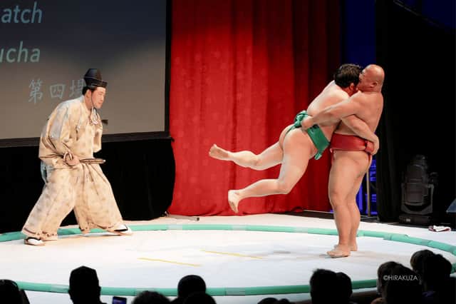 Sumo wrestlers take part in a match as part of the show.