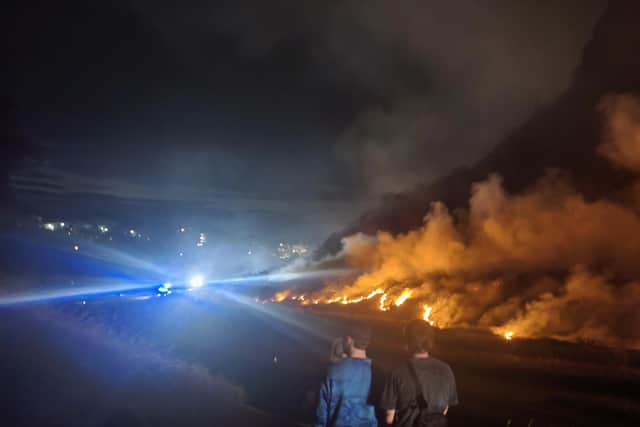 Concerned residents watched on as flames spread across the hill at around midnight