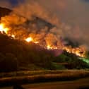 Initially contained to two spots, the fire spread in both directions overnight 