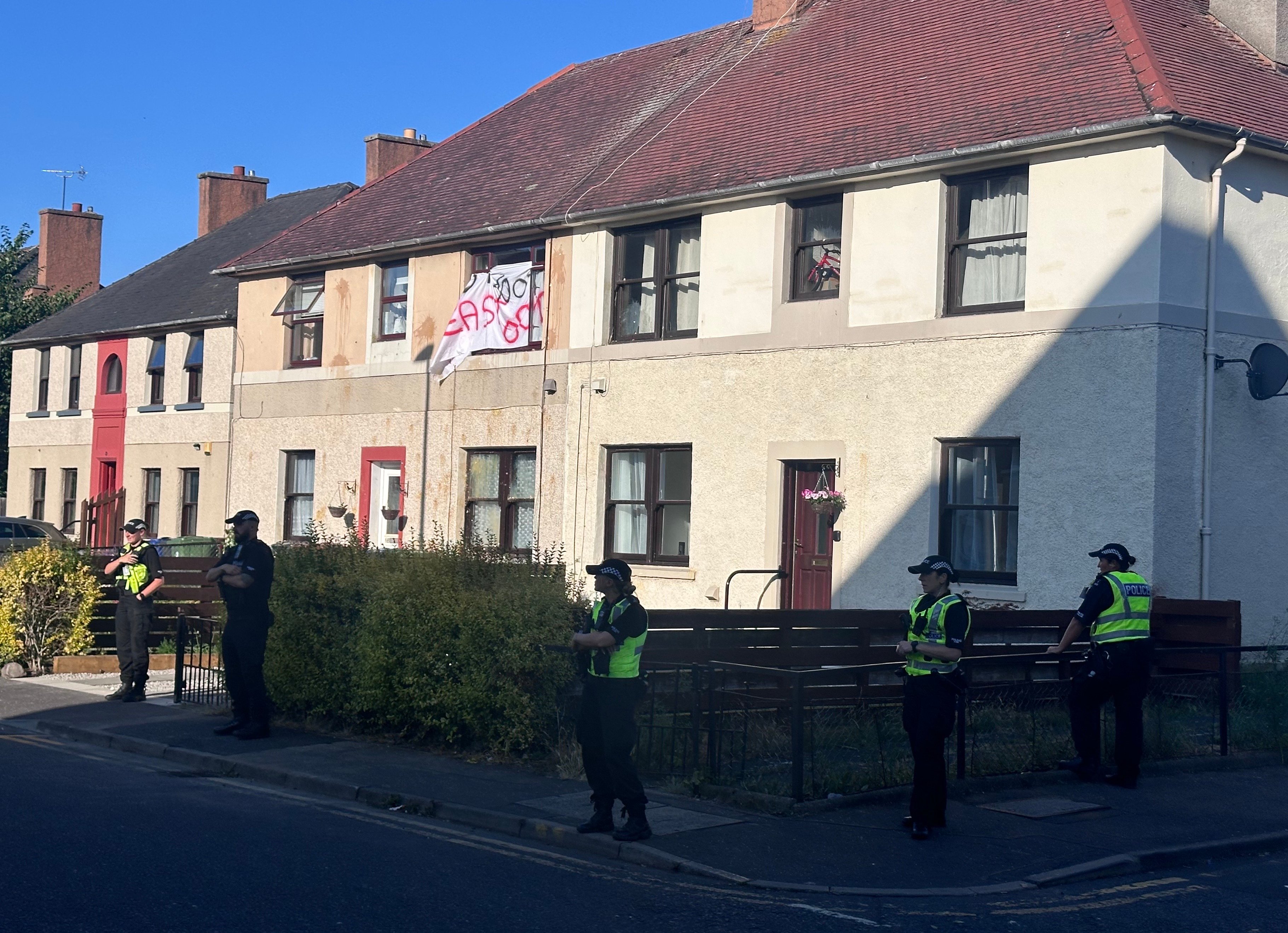 Police forced to lead man to safety after angry mob protest outside ...