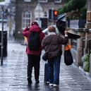 A couple battle with an umbrella in the wind during Storm Eowyn on Princes Street, Edinburgh (Jane Barlow/PA)