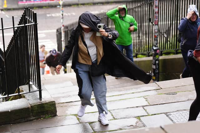 Stock photo of members of the public battling against the wind as they walk in Edinburgh city centre.