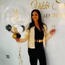Vikki Soloman holding up some balloons