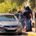 The suspect, widely reported to be Sharif Ahmadzai (centre), being led out of the Athens Court House complex in Kypseli, Athens, where he appeared accused of killing 38-year-old Elisabeth-Jane Ross and disposing of her body in a suitcase.   