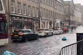 Footage shows Fringe-goers wading through sodden streets.
