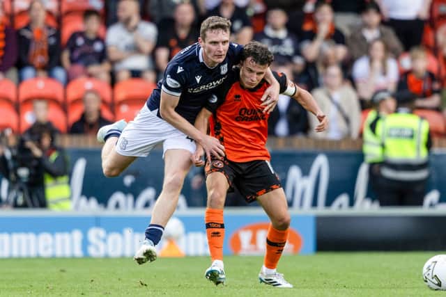 Dundee United's Dylan Tait (R) and Dundee's Ethan Hamilton in action