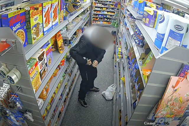 The man could be seen trying to stash items in his pocket
