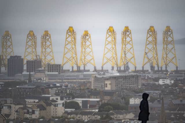 The giant yellow structures visible at the Port of Leith, seen from Calton Hill.