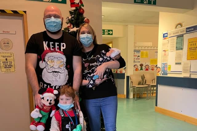 Newborn Joey with his mum Sam, dad Steven, and sister Carly at Christmas.