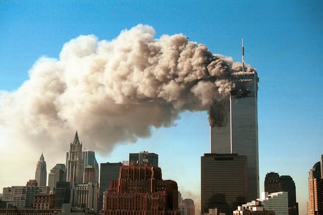 The Twin Towers engulfed by smoke and flames.
