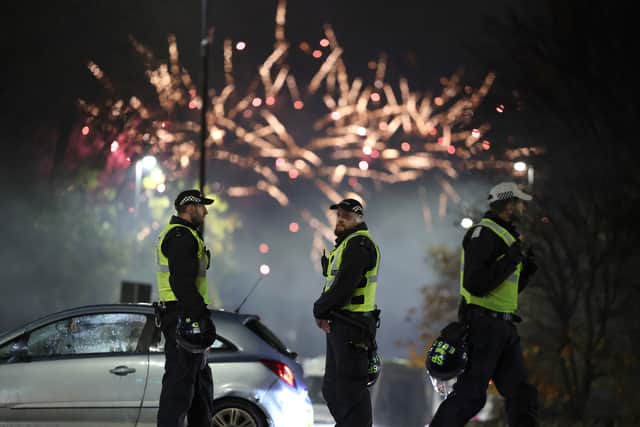 Police officers patrol the streets in Edinburgh as fireworks go off in the distance on November 5 last yea(Picture: Jeff J Mitchell)