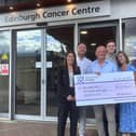 The Muir family photographed with a cheque 