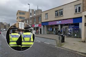 The suspect entered the shop on High Street in Dalkeith armed with a "sharp object" before stealing a number of items. 