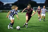 Ainhoa Marin of Real Sociedad runs with the ball under pressure from Lauren Wade of Heart of Midlothian during last week's first leg at Ainslie Park.